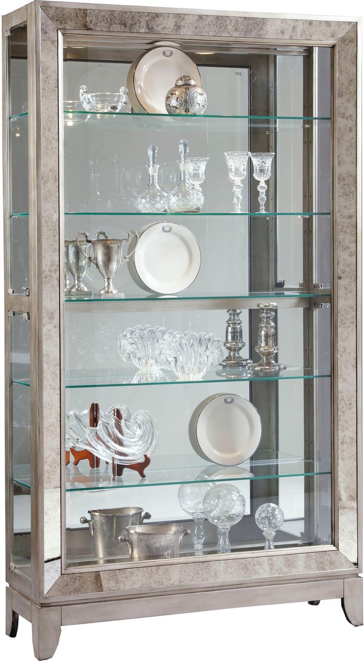 a silver and glass display case with dishes on it's shelves in front of a white background