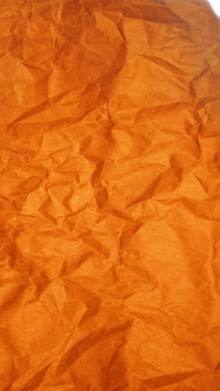 an orange piece of paper that has been wrinkled