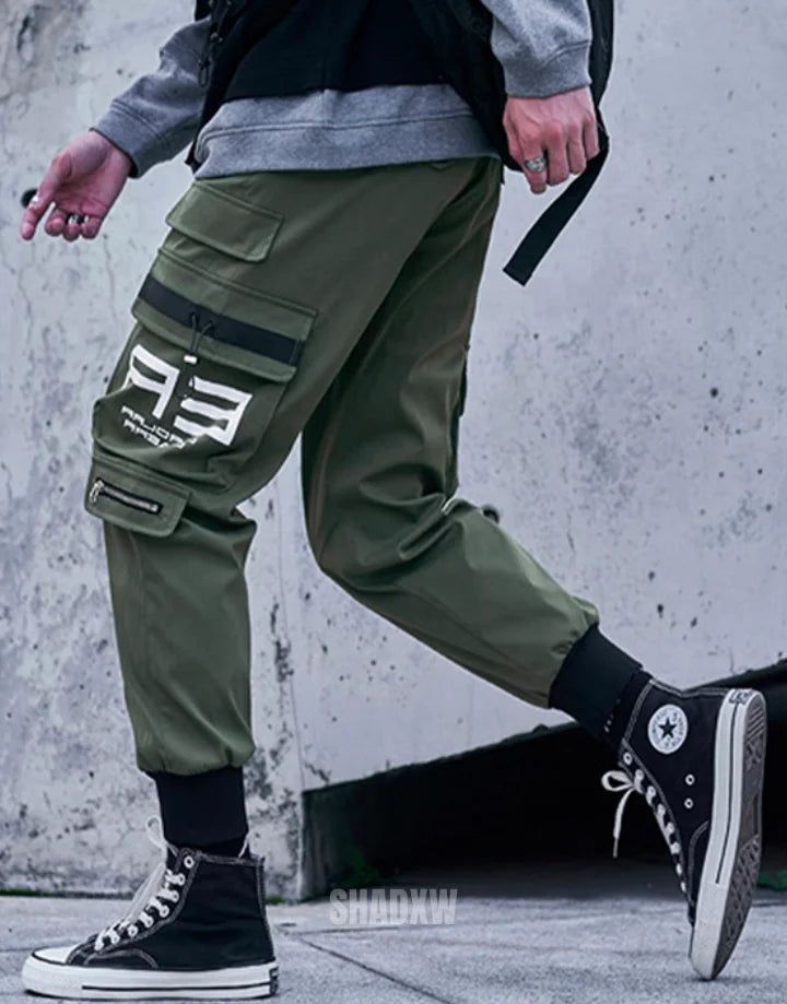 Type: Techwear pants Design: Techwear, streetwear Technical pants: This techwear pants is the perfect garment to complete your Techwear outfit. Premium quality: Reinforced seams, comfortable to wear, soft touch Materials: Polyester Machine washable: 30 °C (86 °F) Size(cm | in) Waist Length Hip S 68 | 26.7 94 | 37 105 | 41.3 M 72 | 28.3 96 | 37.8 110 | 43.3 L 76 | 29.9 98 | 38.6 115 | 45.3 XL 80 | 31.5 100 | 39.4 120 | 47.2 Elevate Your Urban Ensemble with Khaki Pants Streetwear The magic of Khak Urban Parachute Pants For Outdoor, Green Joggers With Pockets For Outdoor Activities, Green Athleisure Cargo Pants For Outdoor Activities, Green Athleisure Cargo Pants For Outdoor, Green Cargo Pocket Joggers For Outdoor, Green Sportswear Pants With Pockets, Urban Cargo Pants For Winter, Urban Style Cargo Pants For Outdoor Activities, Urban Cargo Pants For Outdoor Activities