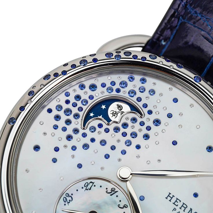 Guaranteed authentic Hermes Arceau Petite Lune Watch featured in the 38 mm large model.This beautiful diamond and sapphire set watch has gems sprinkled on the bezel and on the mother of pearl dial. The moon phase indicator has a blue background and rhodium plated decoration.Steel case is et with 22 (0.25ct) blue sapphires and 10 (0.008 ct) diamonds.Mother of Pearl dial is set with a gem count of 65 (1.188ct) blue sapphires and 58 (0.058ct) diamonds.Interchangeable strap is Blue Sapphire alligato Luxury Blue Watches For Evening, Luxury Blue Evening Watch, Hermes Watch, Hermes Box, Watch Sale, Sapphire Diamond, Moon Phases, Blue Background, Blue Backgrounds