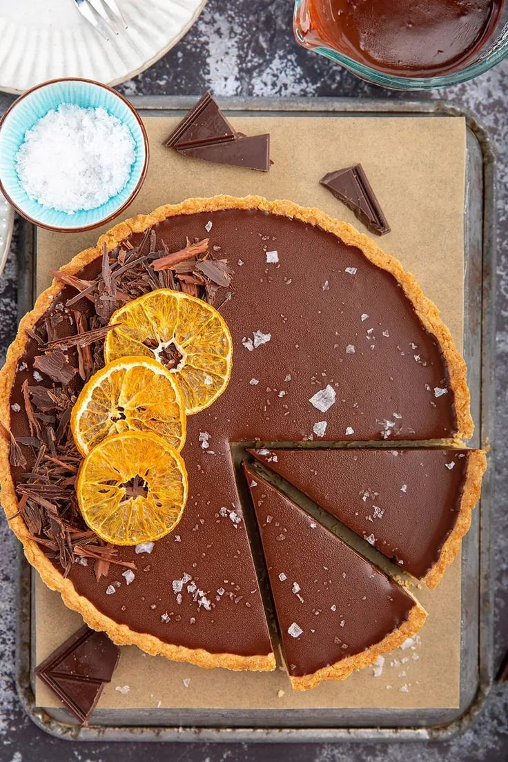 a chocolate tart topped with orange slices