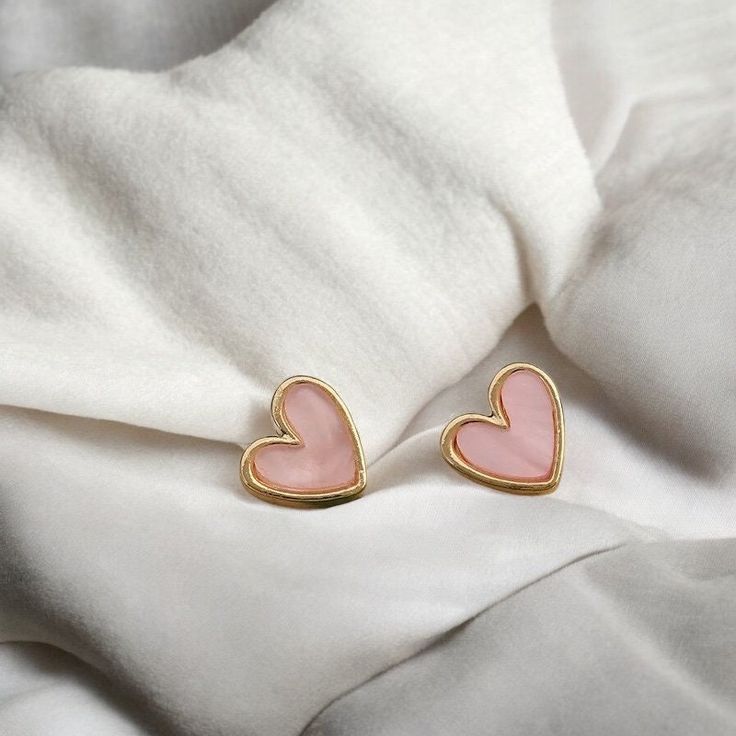 Blush Pink Marble Heart Studs These pink heart studs are accented with a sleek gold band, offering a unique and romantic design. These earrings are a stylish and versatile addition to any jewelry collection. 📦Packaging📦 Our package reflects our commitment to the environment 🌎 simple and minimal. Our jewelry packaging is currently sourced from companies no longer in business, we bought them before they were being thrown out before ever used. As we finish this batch, we're committed to transiti Feminine Gold Earrings For Valentine's Day, Trendy Pink Jewelry For Anniversary, Trendy Pink Heart Earrings For Gift, Trendy Pink Heart Earrings As Gift, Feminine Gold Heart Earrings For Valentine's Day, Trendy Gold Heart Earrings With Heart Beads, Trendy Gold Heart Earrings With Beads, Pink Feminine Earrings For Valentine's Day, Feminine Pink Earrings For Valentine's Day