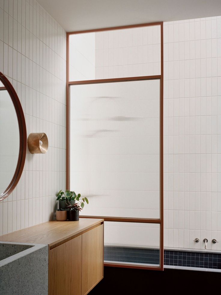 a bathroom with a sink, mirror and bathtub