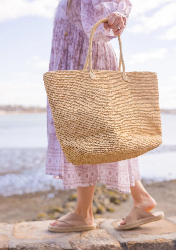 A timeless and chic tote that you can wear from spring to summer! Our Jane tote is a great accessory for running to the market and holding your goodies. Material: 100% Raffia Measurements: 13.5" x 22.8", Handle Drop- 8" Optional leather loop included to carry your fave hat Care: Spot Clean with Damp Cloth Spring Natural Color Double Handle Bag, Spring Natural Double Handle Bags, Natural Color Double Handle Bags For Spring, Bohemian Bags With Leather Handles For Spring, Natural Fiber Double Handle Beach Bag, Spring Beige Bags With Rolled Handles, Spring Handwoven Bag For Daily Use, Handwoven Bags For Daily Use In Spring, Double Handle Natural Fiber Beach Bag