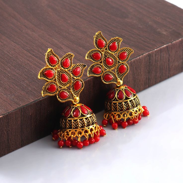 Overview These stylish Jhumki Earrings set from JewelryTrack will certainly leave you spellbound. These Jhumki Earrings set have an excellent finish and gives out an exquisite sense of style. If you are looking for an amazing Fashion Jewelry set for special occasions such as Anniversary, Engagement, Party, Wedding or for gifting , then your search ends here.  Item Description: The look is stunning and preciously suitable for all kinds of dressy occasions. Metal: Brass OCCASION: PARTY WEAR , WEDD Red Earrings For Puja And Festivals, Red Temple Jewelry Earrings For Navratri, Red Jewelry With Latkans For Eid, Red Earrings For Puja And Diwali, Red Meenakari Earrings For Puja, Red Temple Jewelry Chandbalis For Diwali, Temple Jewelry Red Chandbalis Drop Earrings, Red Chandbali Danglers In Temple Jewelry Style, Traditional Red Chandbalis Drop Earrings