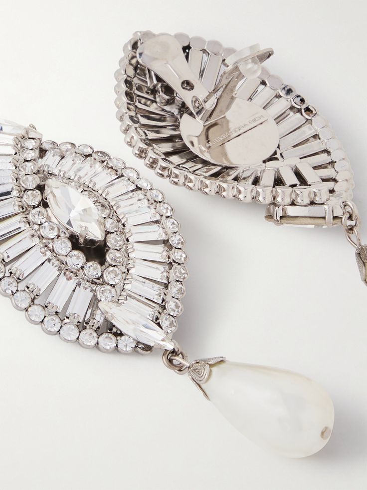 Find ALESSANDRA RICH Tone, Crystal And Faux Pearl Clip Earrings on Editorialist. Alessandra Rich's jewelry has the same glamorous, vintage-inspired appeal as the label's signature dresses - and go just as nicely. Made from silver-tone metal, these statement earrings are traced with shimmering crystals in the shape of a shell and anchored by dangling faux pearls. The clip fastening and surprisingly lightweight feel keep them comfortable. Luxury Crystal Embellished Earrings For Formal Occasions, Diamond Clip-on Jewelry For Parties, Glamorous Crystal Embellished Formal Earrings, Glamorous Crystal Embellished Earrings For Formal Occasions, Luxury Rhinestone Earrings For Wedding, Luxury Rhinestone Wedding Earrings, Glamorous Formal Clip-on Bridal Earrings, Luxury Crystal Embellished Earrings For Party, Luxury Jeweled Earrings For Formal Occasions