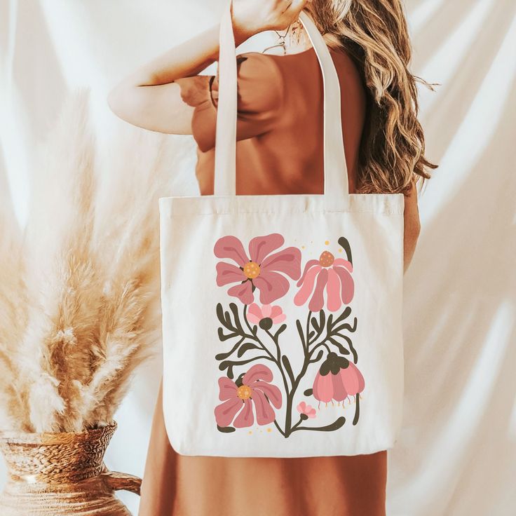 Carry your essentials in style with our 'Boho Floral' tote bag. Adorned with an enchanting array of bohemian-inspired flowers, this bag combines functionality with free-spirited beauty. Crafted from durable materials, it's perfect for day trips, market visits, or everyday use.  This 100% cotton bag comes in one size - 15" x 16"- perfect for everyday wear.  The bag features 20" handles (made from the same canvas), making it easy to carry even with a week's worth of shopping. .: 100% cotton canvas .: Available in natural and black colors .: Heavy fabric (12 oz/yd² (406.9 g/m .: Sewn-in label Bohemian Natural Canvas Bag For Everyday Use, Bohemian Bags For Everyday Use In Spring, Bohemian Bags For Everyday Spring, Bohemian Beach Bag For Everyday Spring Use, Artistic Bags For Everyday Use In Spring, Bohemian Shoulder Bag For Everyday Spring Use, Bohemian Everyday Bags For Spring, Bohemian Canvas Bag With Large Capacity For Everyday, Everyday Bohemian Tote Canvas Bag