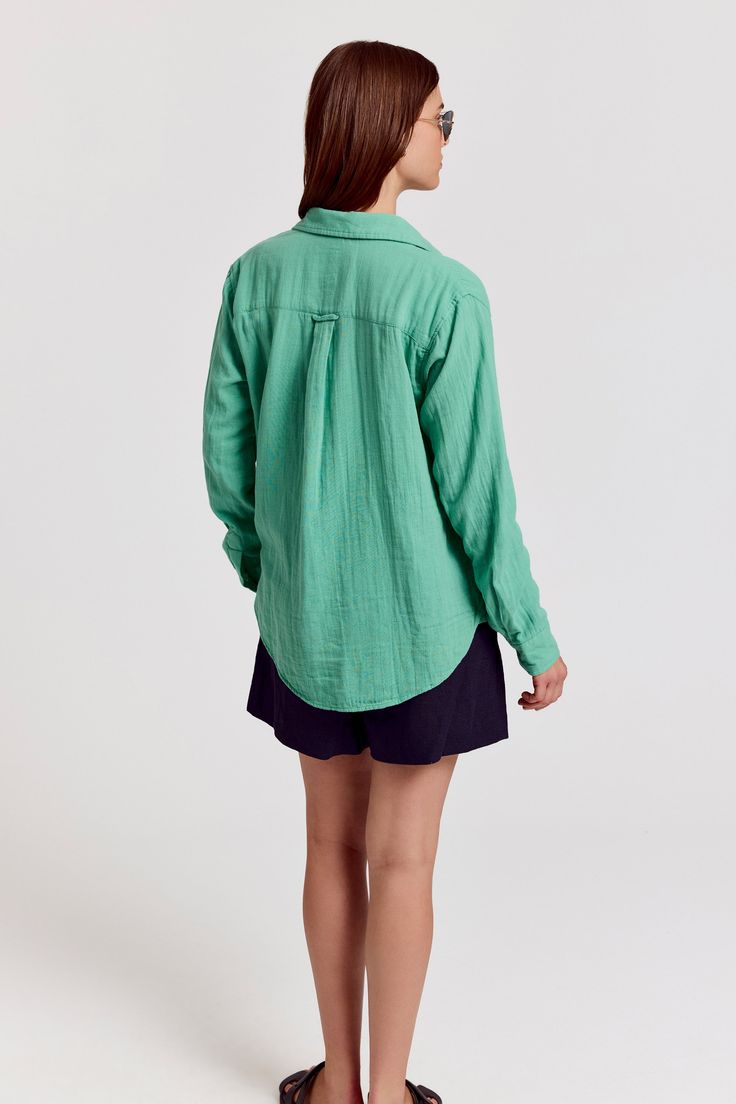 In our softest, custom cotton gauze, The Super Relaxed Boyfriend Shirt in Gauze is loose, drapey, comfortable, and on-trend. Fits like a boyfriend shirt, relaxed throughout, but in our most fun feminine colors of the season.  Push up the sleeves and throw on over a bathing suit or wear it for dinner with a sarong. 

 Rochelle Behrens reimagined how shirts should fit and feel. Our patented No Gape® button technology, seamlessly designed into every shirt and shirtdress we design, eliminates blouse Green Relaxed Fit Shirt With Shirttail Hem, Green Linen Shirt For Daywear, Green Relaxed Fit Top For Daywear, Green Relaxed Fit Blouse For Daywear, Green Linen Tops For Daywear, Green Cotton Blouse With Shirttail Hem, Monogram Shirts, Boyfriend Shirt, Sleeveless Shirt