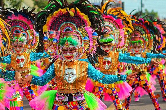 people in colorful costumes are dancing on the street