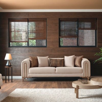 a living room with two couches and a coffee table in front of the window