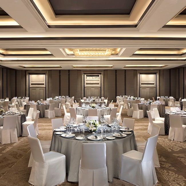 a banquet room set up with tables and chairs