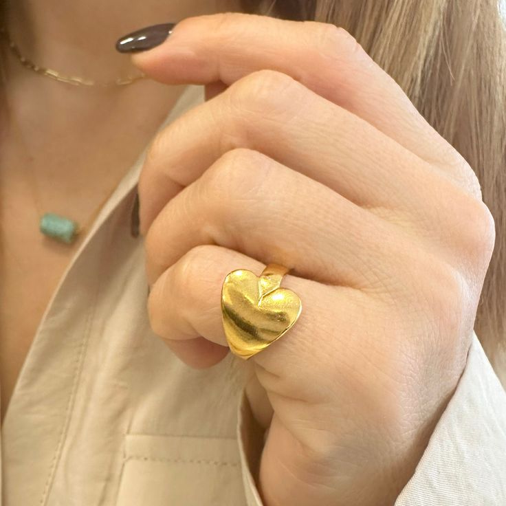 You will love this Heart pinky ring! A Chunky Gold Ring that is heart shaped! A Chevalier gold heart ring that is so cute. A Pinky heart ring handmade in the beautiful island of Milos in Greece!  Material  Pewter with a 24k Gold finish. It is Nickel Free. Size This ring is designed to be a chevalier ring. However, it is adjustable size thanks to the open back part. This heart ring fits great  US size 3.5-4 inch The internal diameter is 15mm Dimensions >> 17.9 x 12.8 mm- 0,7x0,5 inches .   Ideal Ring Minimal, Gold Heart Ring, Ring Heart, Ring Fit, Pinky Ring, Ring Finger, Gold Heart, Beautiful Gift Boxes, Ring Handmade