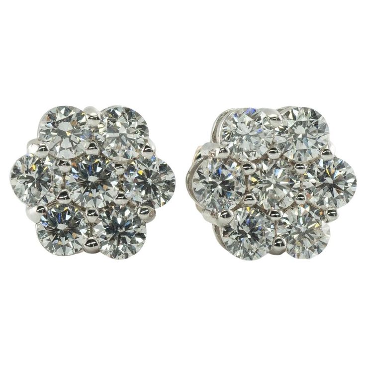 Diamond Earrings Studs 14K White Gold Cluster 1.12 TDW This pair of diamond cluster studs is crafted in solid 14K White Gold. There are seven natural round brilliant cut diamonds totaling 1.12 carats for the pair. The diamonds are VS2-SI1 clarity and HI color. The earrings are equipped with long posts and butterfly backings. The top of the earrings measures 9mm. The earrings weigh 2.7 grams. Great estate condition. Dazzling Cluster Diamond Earrings For Formal Occasions, Dazzling Cluster Diamond Earrings For Formal Events, Classic Single Cut Diamond Cluster Earrings, Classic Round Cut Single Diamond Cluster Earrings, Fine Jewelry Diamond Cluster Earrings, Round Cluster Earrings With Diamonds, Fine Jewelry, Formal Cluster Diamond Earrings With Brilliant Cut, Platinum Cluster Diamond Earrings For Formal Occasions, Luxury Cluster Diamond Earrings With Single Cut Diamonds