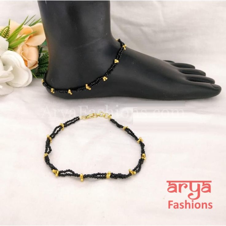 Golden Black Beads Mangalsutra Anklet Pair with CZ Stones Traditional Black Bracelets For Party, Traditional Black Party Bracelets, Black Bracelets With Tiny Beads For Party, Black Beaded Anklets For Festival, Black Beaded Festival Anklets, Traditional Black Beaded Bracelet, Adjustable Black Anklet With Tiny Beads, Traditional Black Beaded Bracelets With Tiny Beads, Traditional Black Beaded Bracelets For Festive Occasion