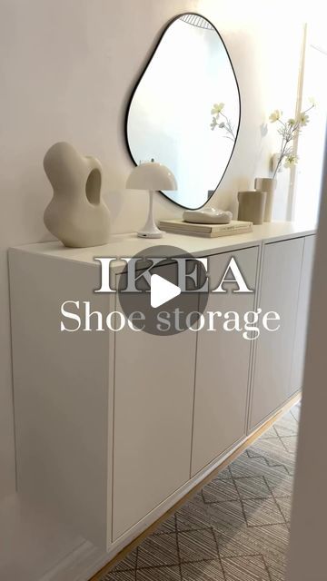 a white dresser with a mirror and vases on it in a room that has tile flooring