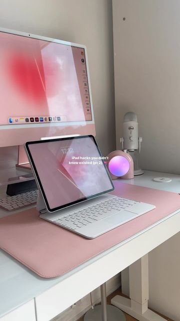 a laptop computer sitting on top of a pink desk