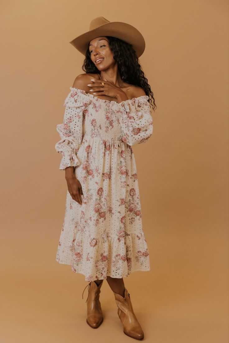 Printed in perfect florals, this midi dress features a smocked bodice, a tiered silhouette, and poet sleeves that can be worn on or off the shoulders for the dreamiest fit. Made of soft cotton and complete with eyelet detailing, this dress is the epitome of charming elegance. lined bodice and skirt unlined sleeves pockets // paired with the free people new frontier western boots in peru Eyelet Dress, Summer Sale, Western Boots, Smocking, Off The Shoulder, Bodice, Midi Dress, Floral