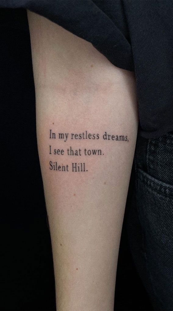 a person with a tattoo on their arm that reads, in my restless dreams, i see that town silent hill