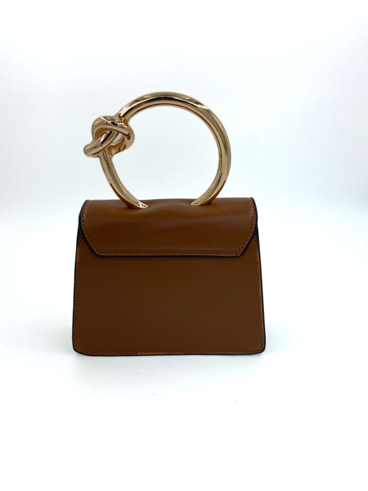 Gold circular handle structured handbag with detachable crossbody chain. Top Handle Satchel With Handles As Fashion Accessory, Daily Shoulder Bag With Metal Hardware And Round Handle, Daily Use Shoulder Bag With Metal Hardware, Brown Satchel With Round Handle And Gold-tone Hardware, Brown Satchel With Gold-tone Hardware And Round Handle, Top Handle Satchel With Detachable Strap, Top Handle Satchel With Detachable Handle, Satchel With Detachable Top Handle, Fashion Accessory Satchel With Detachable Top Handle