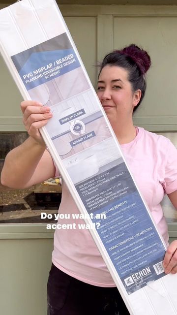 a woman holding up a large piece of paper with the words, do you want an accent wall?