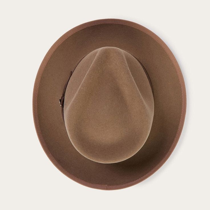 An icon of the Stetson brand, the Whippet Fedora epitomizes the sophisticated style of the American post-war era with its timeless, versatile profile and a brim that can look casual and cool when snapped up, or snapped down for a dressed-up and dapper look. Handcrafted with a firm finish from high-quality 100% wool felt and richly dyed in versatile shades, the Whippet features a slightly tapered 4 ½" pinch front teardrop crown and a 2 ⅜” bound edge brim. Its classic style is underscored by a gro Classic Panama Hat With Curved Brim For Fall, Classic Fedora With Curved Brim For Fall, Classic Curved Brim Fedora For Fall, Flat Crown Fur Felt Fedora, Vintage Fall Felt Hat, Solid Wide Brim Fur Felt Hat, Solid Color Wide Brim Fur Felt Hat, Curved Brim Fur Felt Top Hat For Fall, Fitted Wool Felt Hat For Rodeo