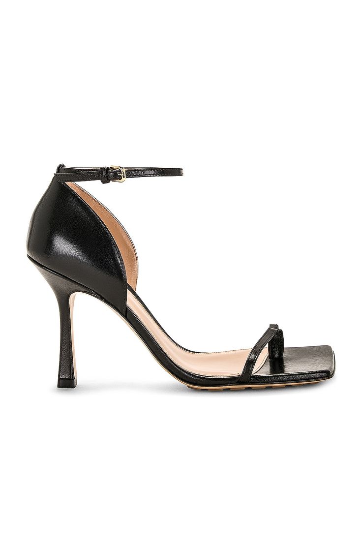 Find BOTTEGA VENETA Stretch Sandal on Editorialist. Bottega Veneta Stretch Sandal in Black Lambskin leather upper with rubber-injected leather sole. Made in Italy. Ankle strap with buckle closure. Toe loop. Lambskin leather lining. Square toe with block heel. Approx 95mm/ 3.75 inch heel. BOTT-WZ409. 729742-VBSF0-1000. About the designer: Bottega Veneta – inspiring individuality with innovative craftmanship since 1966. Creativity lies at the heart of all that we do. Born in Vicenza the house is rooted in Italian culture yet maintains a truly global outlook. An inclusive brand with exclusive products Bottega Veneta is as much of a feeling as it is an aesthetic. Leather Ankle Strap Evening Sandals, Evening Leather Sandals With Ankle Strap, Evening Sandals With Padded Heel In Calf Leather, Sleek Calf Leather Sandals With Padded Heel, Calf Leather Sandals With Heel And Toe Straps, Leather Sandals With Heel Loop For Gala, Calf Leather Sandals With Padded Heel And Ankle Strap, Calf Leather Sandals With Ankle Strap And Padded Heel, Ankle Strap Sandals With Padded Heel In Calf Leather