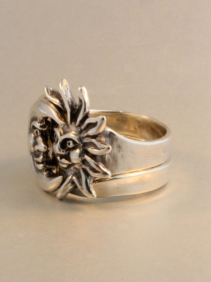 The solid sterling silver Eclipse ring is a striking two part ring set. The Moon half of the ring nestles securely into the rays of the Sun. We have many ring sizes immediately available. We will contact you to let you know if we have your chosen ring size in stock or when to expect shipment. All Marty Magic Jewelry is packaged in a beautiful ring box embossed with the gold foil Marty Magic dragon logo. Perfect for any occasion! Designed in Santa Cruz, California by Marty Magic. Made in the U.S. Celestial Silver Rings With Polished Finish, Spiritual Open Ring With Sun And Moon Design, Symbolic Sun And Moon Open Ring, Silver Anniversary Rings With Sun And Moon Design, Silver Celestial Open Ring, Unique Adjustable Sun And Moon Design Rings, Sterling Silver Sun And Moon Promise Ring, Silver Ring With Sun And Moon Design, Symbolic Sterling Silver Ring With Sun And Moon Design