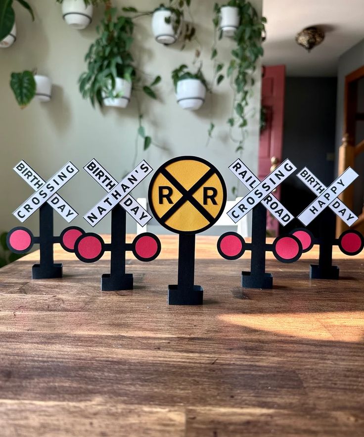 four railroad crossing signs are sitting on a table