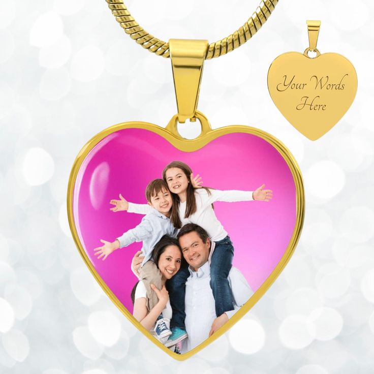 a heart shaped pendant with an image of two women and a child on it, hanging from a gold chain