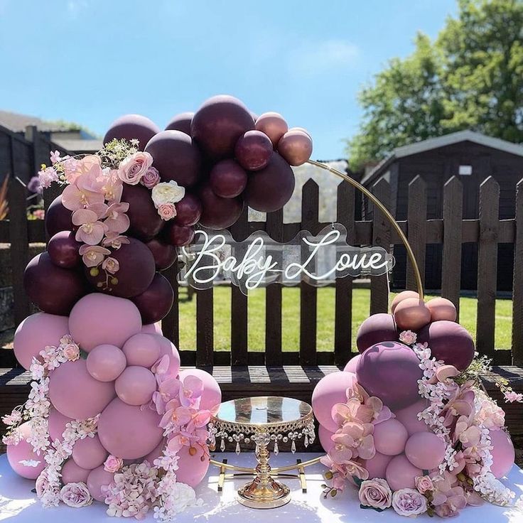 a table topped with lots of balloons and flowers