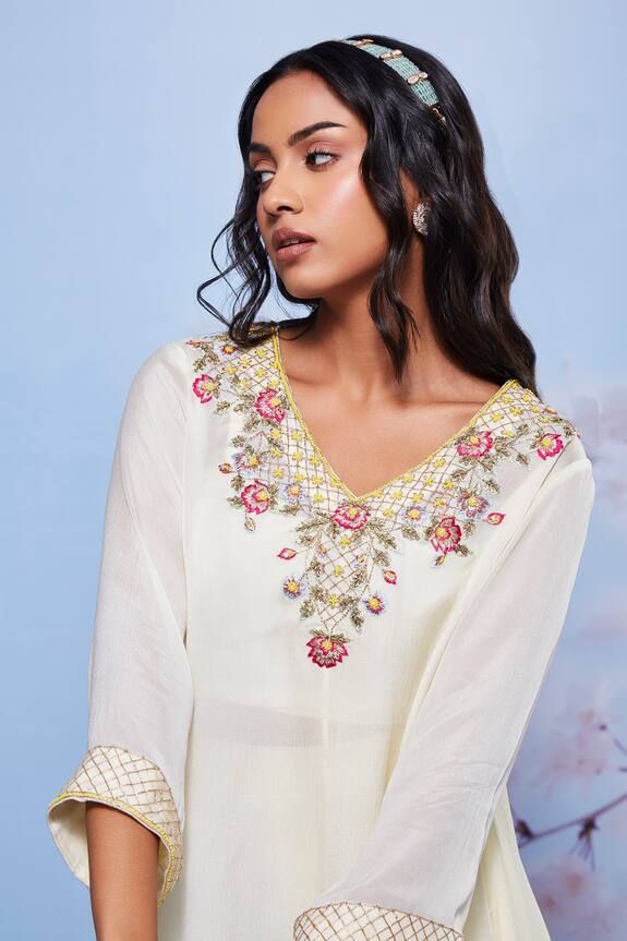 Ivory asymmetrical kurta with intricate floral embroidered neckline. Comes with a sharara and a fitted bustier.
Components: 3
Pattern: Embroidered
Type Of Work: Floral
Neckline: V-Neck
Sleeve Type: Straight Three Quarte
Fabric: Chiffon/Cotton Lycra
Color: Ivory
Other Details: 
Asymmetric hem kurta
Occasion: Mehendi and Haldi - Aza Fashions Kurta And Sharara Set, Kurta And Sharara, Tarun Tahiliani, Luxury Sale, Sharara Set, Embroidered Neckline, Modern Bride, Color Ivory, Set For Women