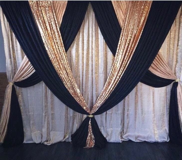 black and gold drapes are hanging on the wall