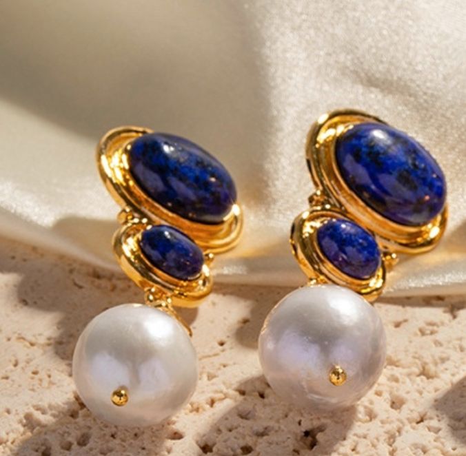 Lapis Lazuli Elegance Lustrous Gemstones: The Lapis Lazuli Elegance Earrings feature a design that embodies timeless beauty and contemporary grace. The deep blue Lapis Lazuli stones, known for their association with wisdom and truth, serve as the centerpiece, exuding an air of elegance and mystery. A delicate pearl drop enhances the design, adding a touch of luster and sophistication. Delicate Pearl Accent: Lapis Lazuli Elegance Earrings, a harmonious fusion of sophistication and the mesmerizing Blue Pearl Earrings Fine Jewelry For Formal Events, Blue Pearl Earrings For Formal Occasions, Blue Pearl Earrings For Formal Events, Luxury Blue Pearl Earrings For Anniversary, Blue Gemstone Luxury Pearl Earrings, Blue Luxury Pearl Earrings With Gemstone, Luxury Blue Gemstone Pearl Earrings, Luxury Blue Pearl Drop Earrings, Elegant Gold Lapis Lazuli Earrings