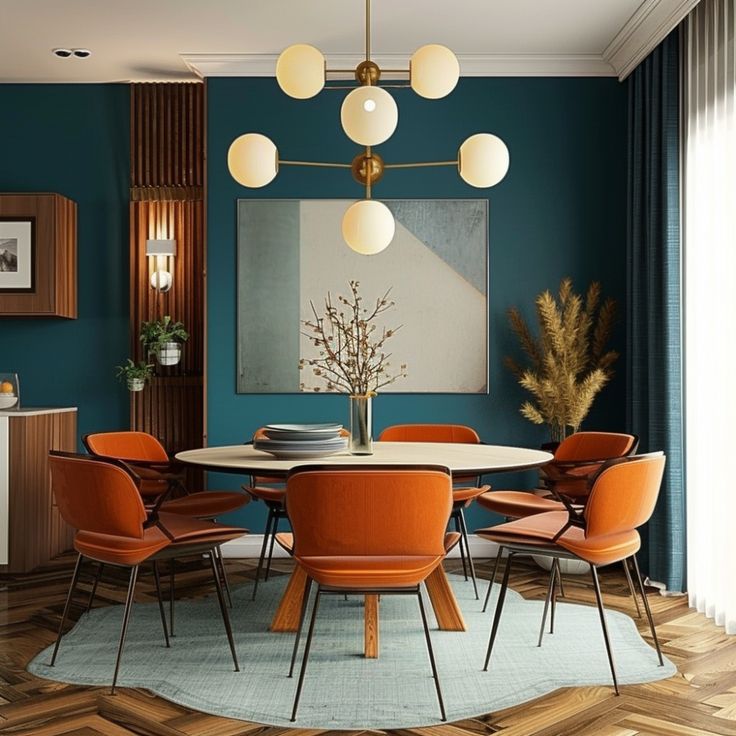 a dining room with teal walls and orange chairs around a round table in the center