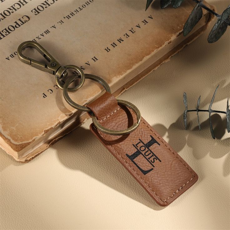 a leather keychain sitting on top of an old book