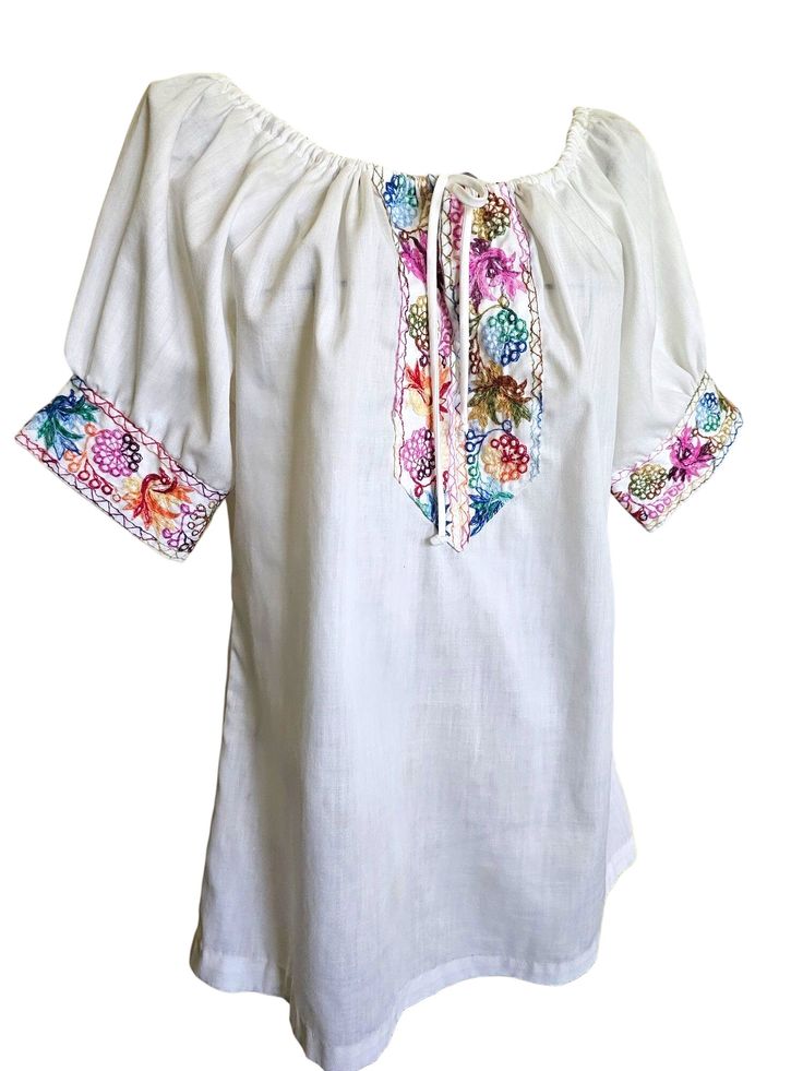 Women's vintage floral embroidered Mexican peasant top. Short sleeve, multiple bright colored floral embroidered collar with tie neckline. no tag ~ size medium Bohemian Peasant Top With Multicolor Embroidered Neckline, Bohemian Peasant Top With Embroidered Neckline For Spring, Spring Multicolor Embroidered Peasant Top, Folk Peasant Top With Multicolor Embroidered Neckline, Folk Style Peasant Top With Floral Embroidery For Spring, Spring Peasant Top With Multicolor Embroidered Neckline, Summer Peasant Blouse With Embroidered Neckline, Folk Style Floral Embroidered Peasant Top For Spring, Peasant Blouse With Multicolor Embroidery For Spring