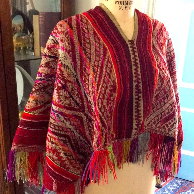 This Is A Beautiful Hand Woven And Super Bright Colors Peruvian Poncho. It Has Fringe All The Way Around. It Is In Very Good Condition. Just One Tiny Snag And A Little Loosening On The Back At The Shoulders. Please See The Last Two Photos. It Is One Size But Measures Shoulder To Shoulder About 16 Inches, And Shoulder To The End Of The Fringe Is About 23 Inches. The Back Hangs Lower Than The Front Of The Poncho. Great Looking Heavy Woven Fabric With Amazing Pinks Reds And Oranges! A Great Additio Traditional Fringe Poncho One Size, Red Folk Style Poncho For Festival, Hippie Poncho With Tassels, Hippie Fringe Shawl Poncho, Traditional Fringe Poncho For Fall, Traditional Fall Poncho With Fringe, Handwoven Poncho Shawl For Festivals, Handwoven Festival Poncho Shawl, Bohemian Handwoven Shawl Poncho