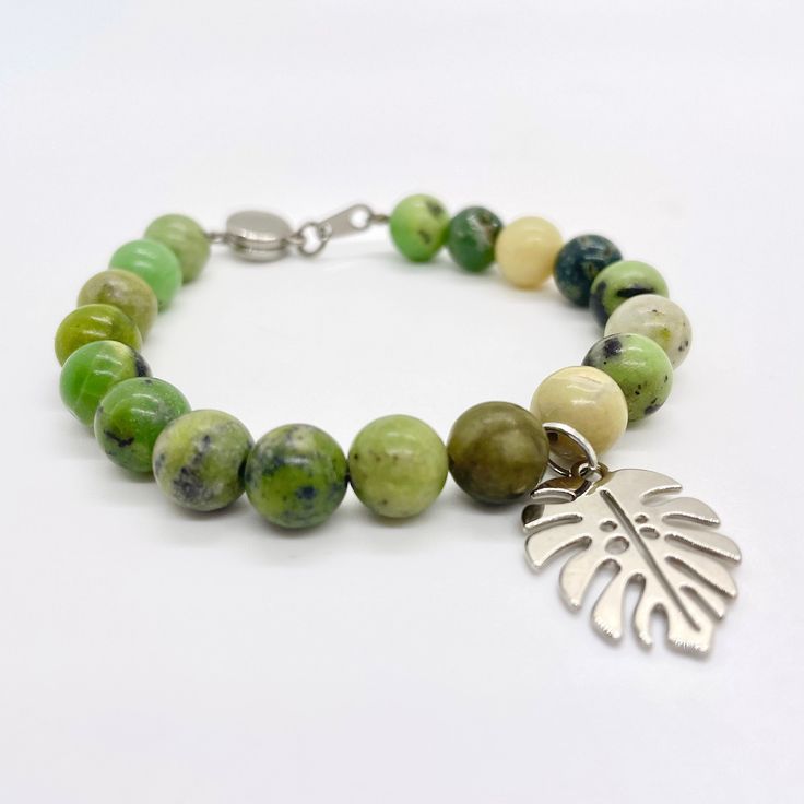 "Growth" In Feng Shui, the Monstera brings luck and growth. Plus, let's be honest, it's a plant moms favorite. It's okay, we won't tell the other plants! This bracelet is made of natural Australian jade stone beads and a silver plated Monstera leaf charm. The closure is magnetic. Please be sure to measure your wrist correctly BEFORE buying! I want you to be 100% happy with your purchase and being sure you are selecting the proper size bracelet before finalizing your purchase plays a big part in Green Beaded Bracelets For Gifts, Nature-inspired, Nature-inspired Green Beaded Bracelets For Gift, Green Nature-inspired Beaded Bracelets For Gift, Green Nature-inspired Beaded Bracelets As Gift, Nickel-free Green Beaded Bracelets As A Gift, Nickel-free Green Beaded Bracelets For Gift, Nickel-free Green Beaded Bracelet For Gift, Green Nickel-free Beaded Bracelets As A Gift, Nature-inspired Green Bracelets With Natural Stones