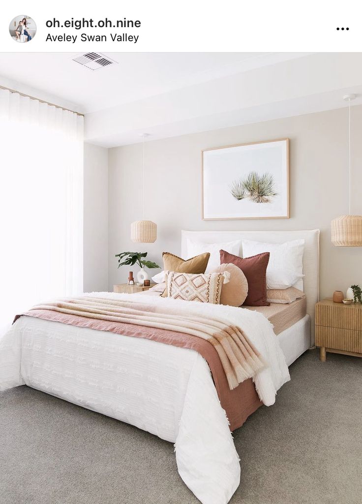 a bedroom with white walls and beige carpet