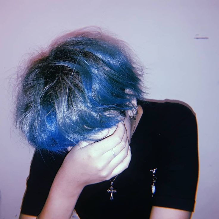 a woman with blue hair covering her face