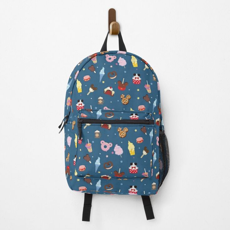 a backpack hanging on a wall with donuts and cupcakes all over it