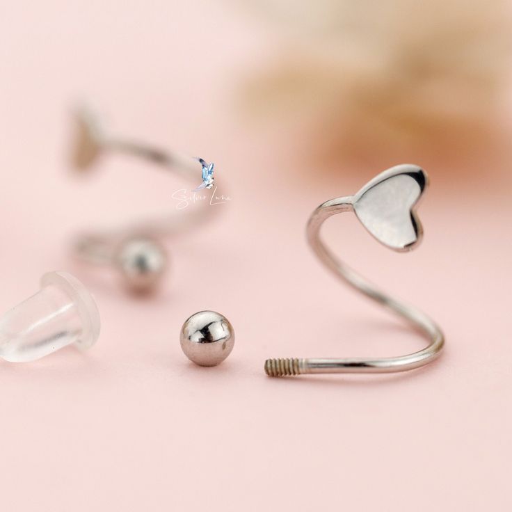 These cute, elegant spiral heart earrings features Valentine heart shape and screw ball back at one end to keep the earrings secured. These cute Valentine spiral heart earrings are comfortable to wear everyday. Add these cute spiral heart earrings to your everyday fine jewelry collection or as gift for your love one. These earrings are made of solid 925 sterling silver with gold plate or platinum plate to create color options. Jewelry Care: See more information about how to care for your jewelry Silver Heart Piercings For Valentine's Day, Adjustable Silver Heart Piercings, For Your Love, Fine Jewelry Collection, Valentine Heart, Heart Earrings, Heart Shape, Solid 925 Sterling Silver, Jewelry Care