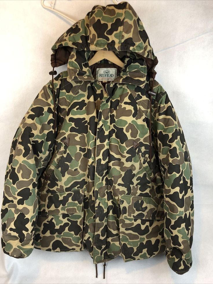 a camouflage jacket hanging on a clothes hanger