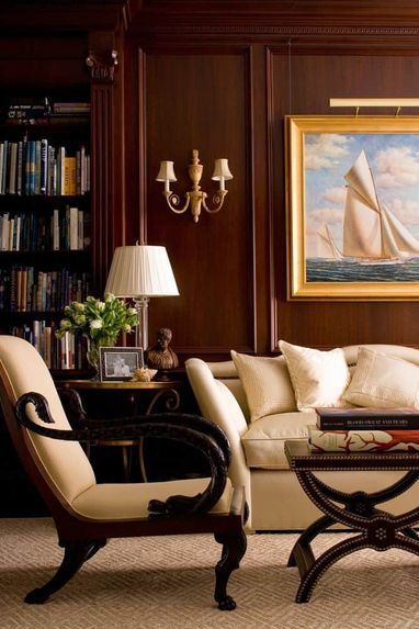 a living room filled with furniture and a painting on the wall