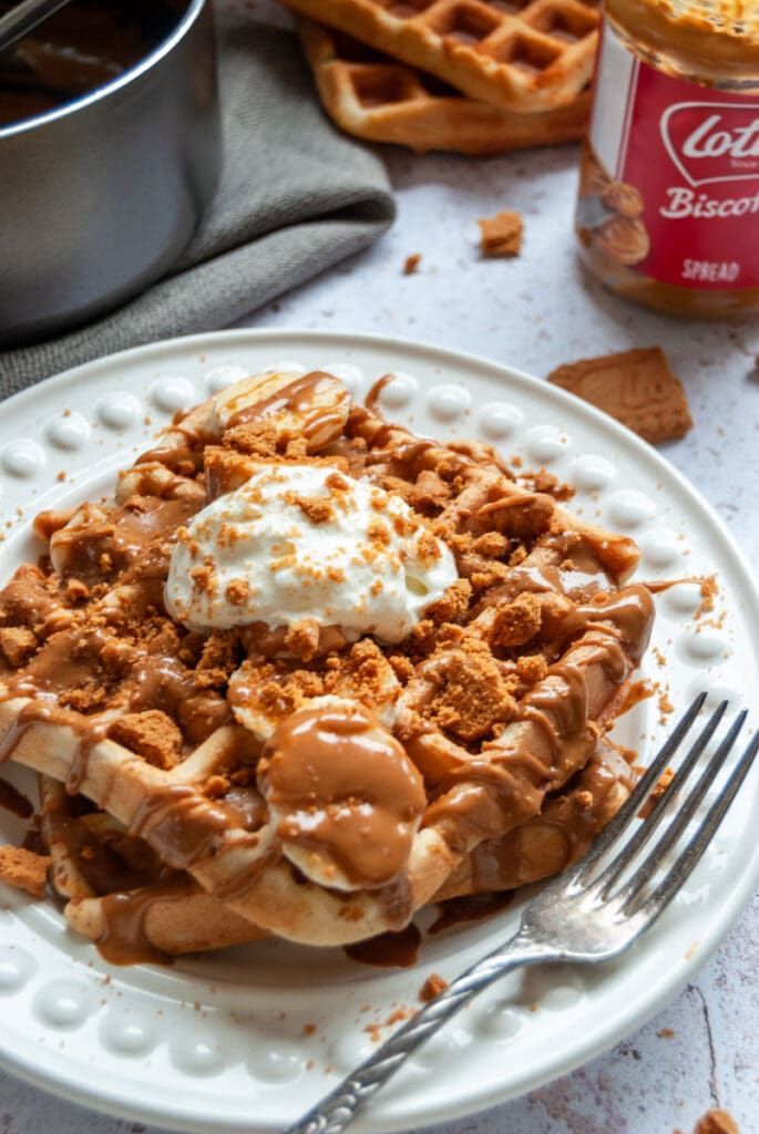 a waffle topped with ice cream and caramel