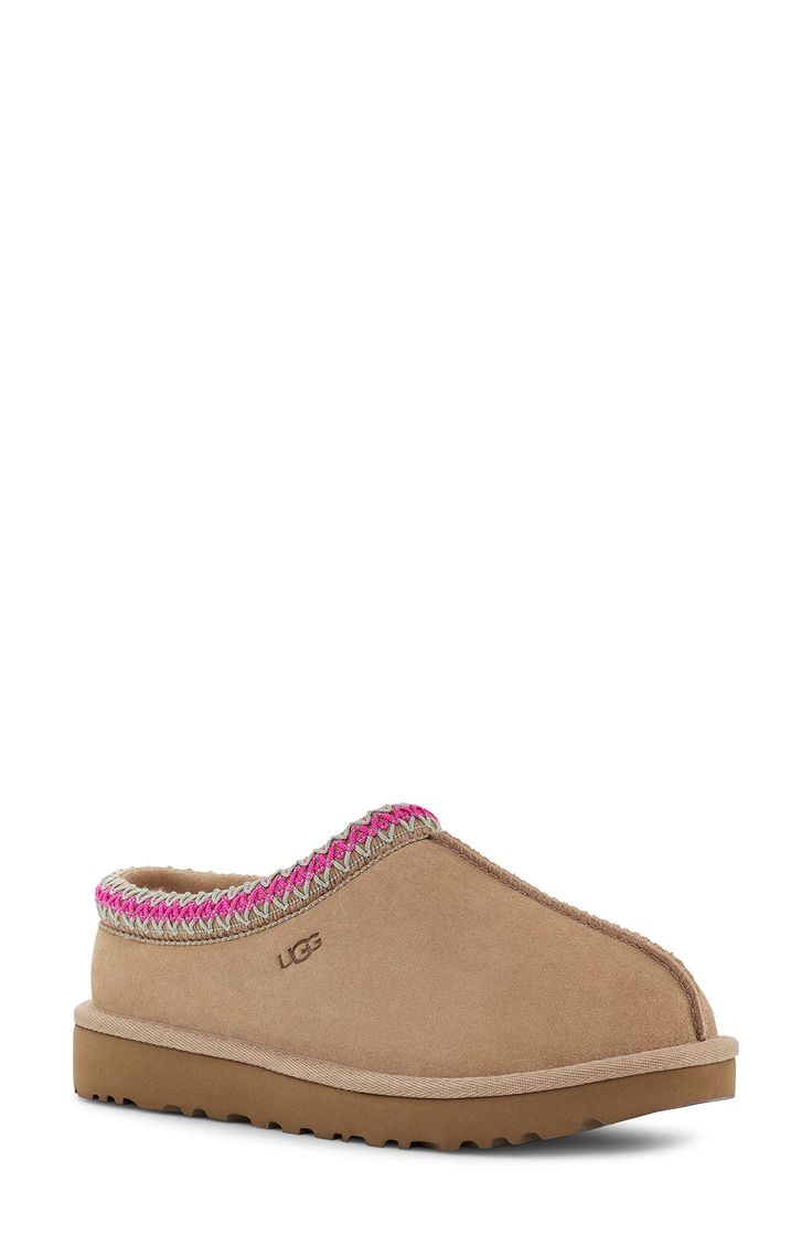 A warm, suede slipper with embroidered trim and a plush genuine-shearling lining can be worn in or out of the house thanks to the grippy sole. Slight dye transfer may occur with darker colors during first few wears Leather upper/genuine-shearling or genuine-shearling and UGGpure wool lining/rubber sole Shearling may be sourced from Australia, Ireland, Spain, the UK or the USA. See packaging for confirmed country of origin UGGpure, a moisture-wicking textile made entirely from wool but crafted to Pink Ugg Tasman, Ugg Tasmans, Cute Uggs, Pretty Sneakers, Shoes For School, Pink Uggs, Ugg Tasman Slippers, Trendy Shoes Sneakers, Preppy Shoes