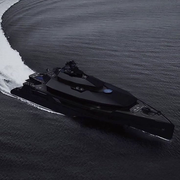 a large black boat traveling through the ocean