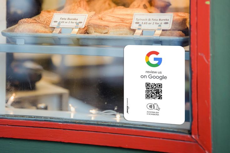 there is a sign on the glass window that says google and bread in front of it