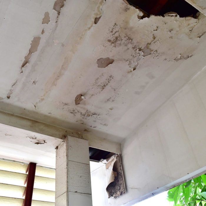 the ceiling in an old house has chipped paint on it and is peeling off