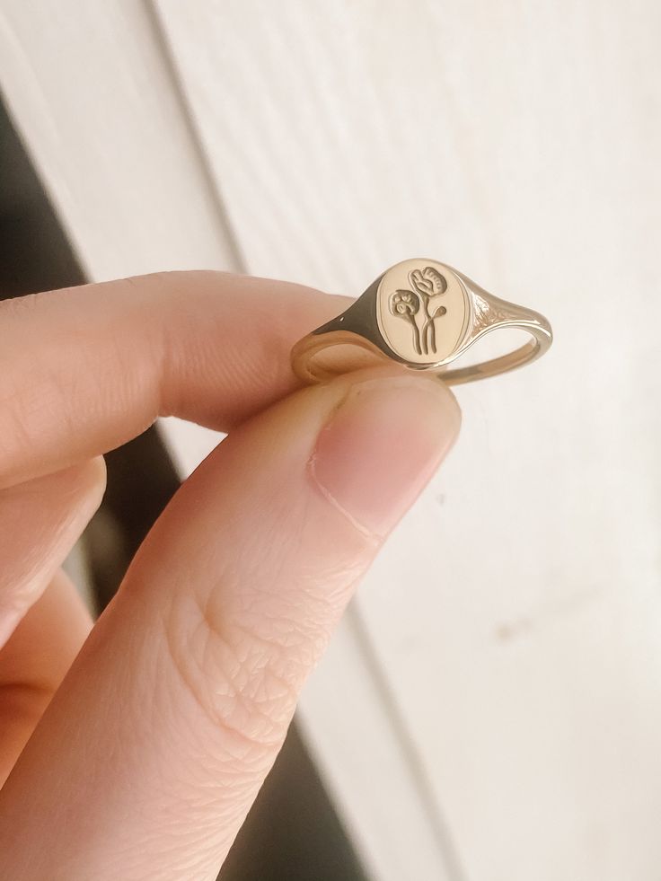 Mini Poppy signet ring cast from an original hand engraved piece. Face of Ring Width: 8mm Height: 7mm Band Width: 1mm Thickness: 1mm *Please note that brass may leave a harmless green mark on the skin depending on your body chemistry. A clear coat of nail polish can be applied to the inside of the ring to remedy this. Return to shop: https://www.etsy.com/shop/ClausJewelry?ref=hdr_shop_menu Follow us on instagram @ClausJewelry Checkout our website! www.ClausJewelry.com Claus Jewelry, Flowers Ring, Kingston Ny, Gold Rings Stackable, Birthday Flower, Logo Gifts, Wedding Rings Unique, Finger Rings, Nails And Makeup